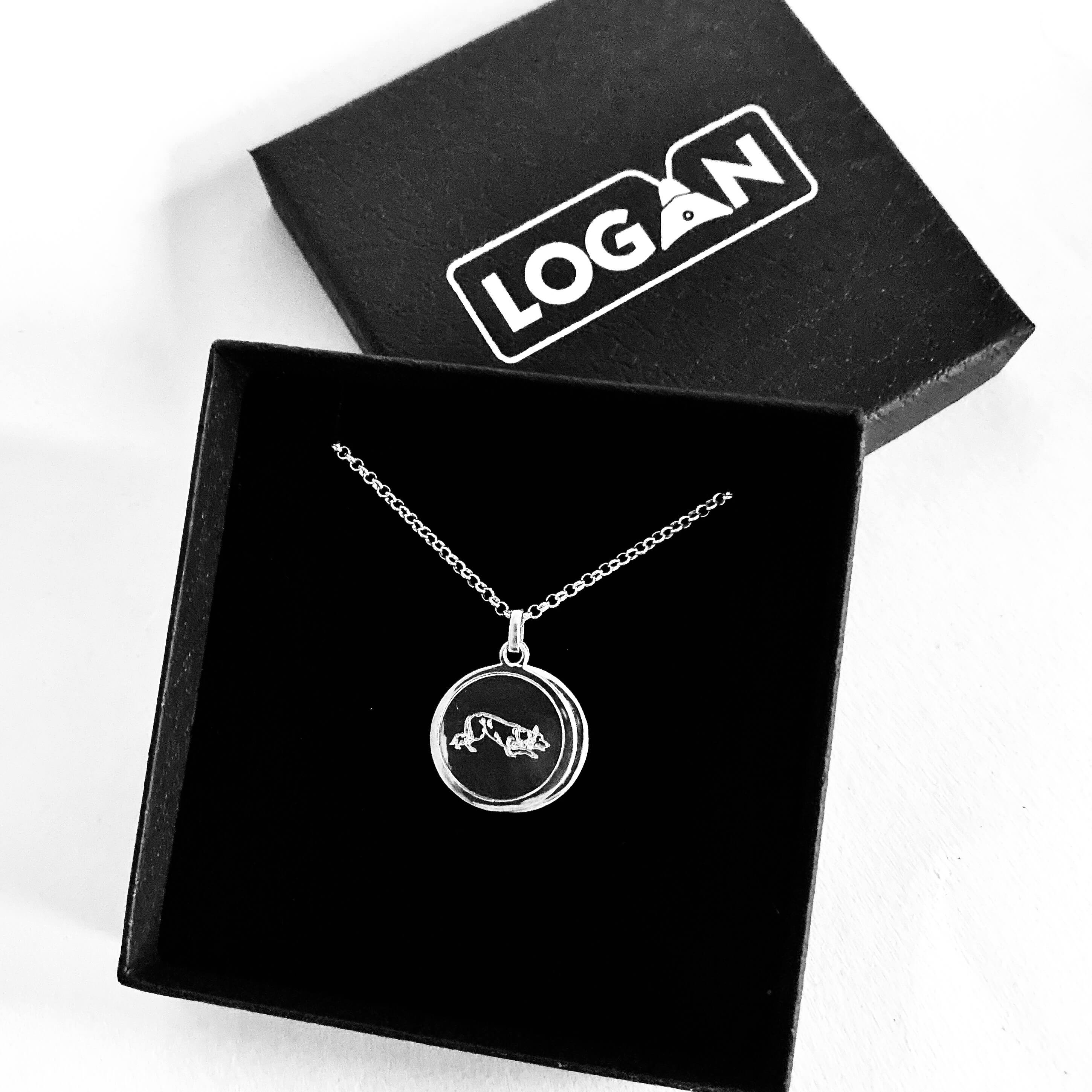 Necklace with a pendant in a black box with 'LOGAN' branding on a white background