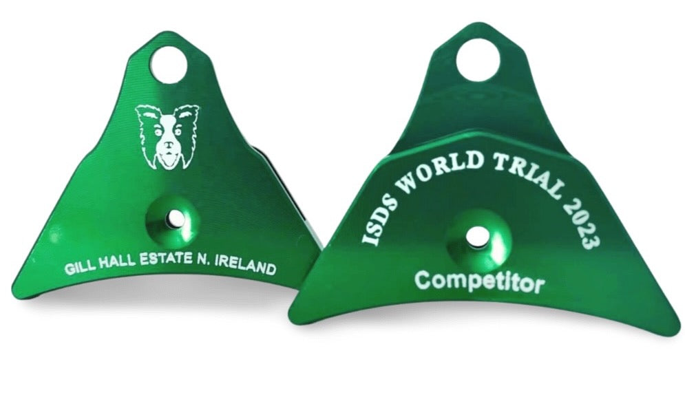 Two green Logan whistle dog training tools with ISDS World Trial 2023 engraving