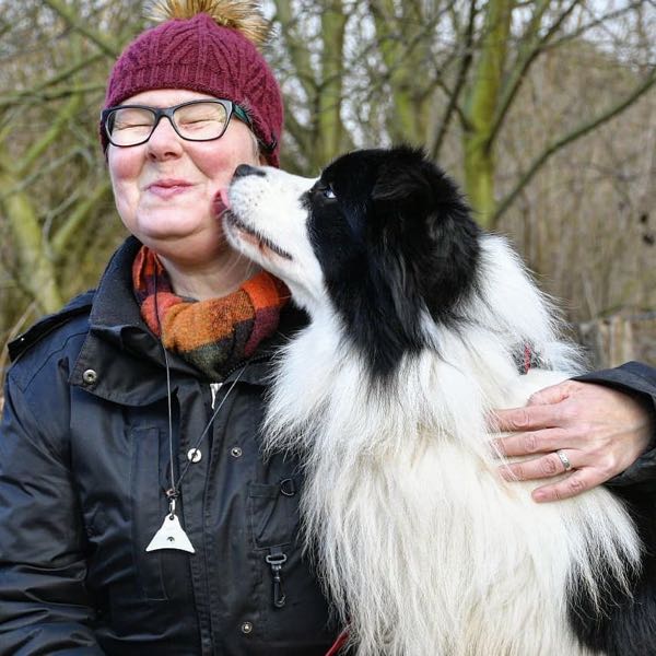 Border collie with woman wearing Logan Whistle