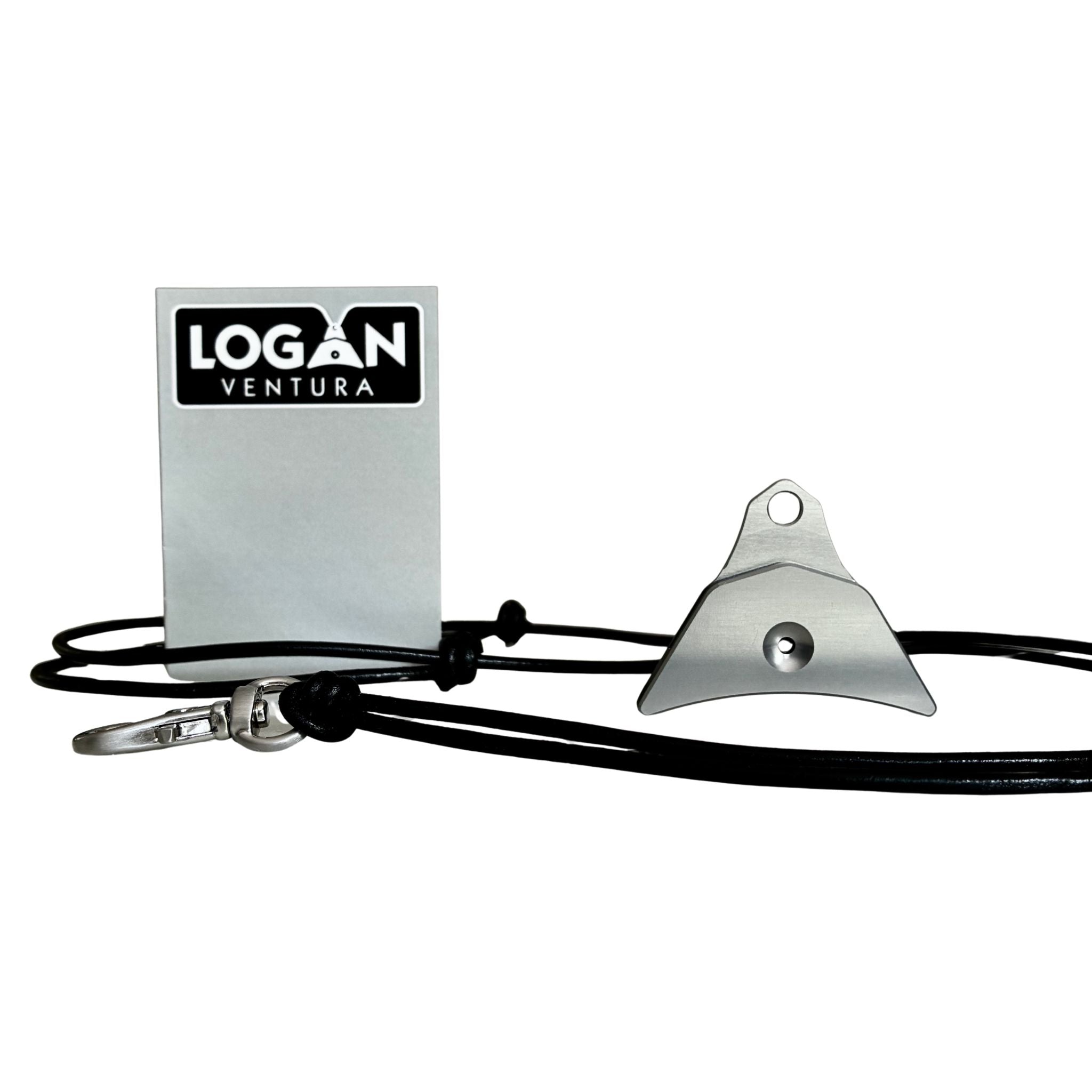 A grey anodised Logan ventura sheepdog whistle attached to a black cord lanyard with a silver swivel clip, shown next to a silver label 'LOGAN VENTURA' on a white background.