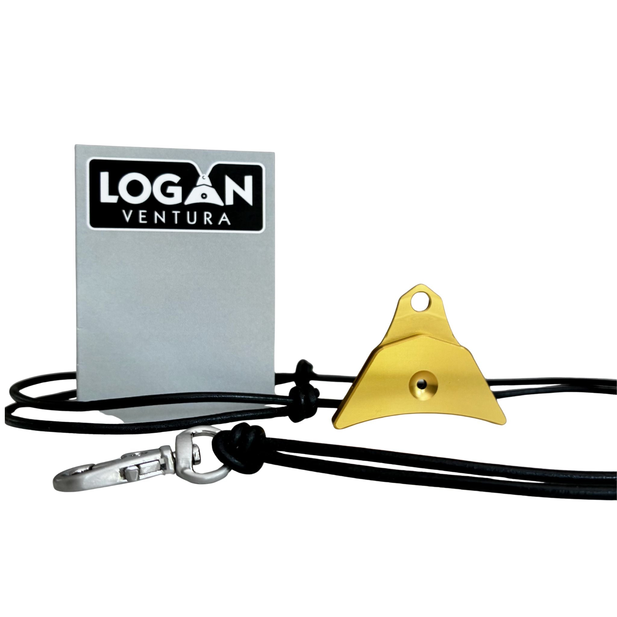 A gold anodised Logan ventura sheepdog whistle attached to a black cord lanyard with a silver swivel clip, shown next to a silver label 'LOGAN VENTURA' on a white background.