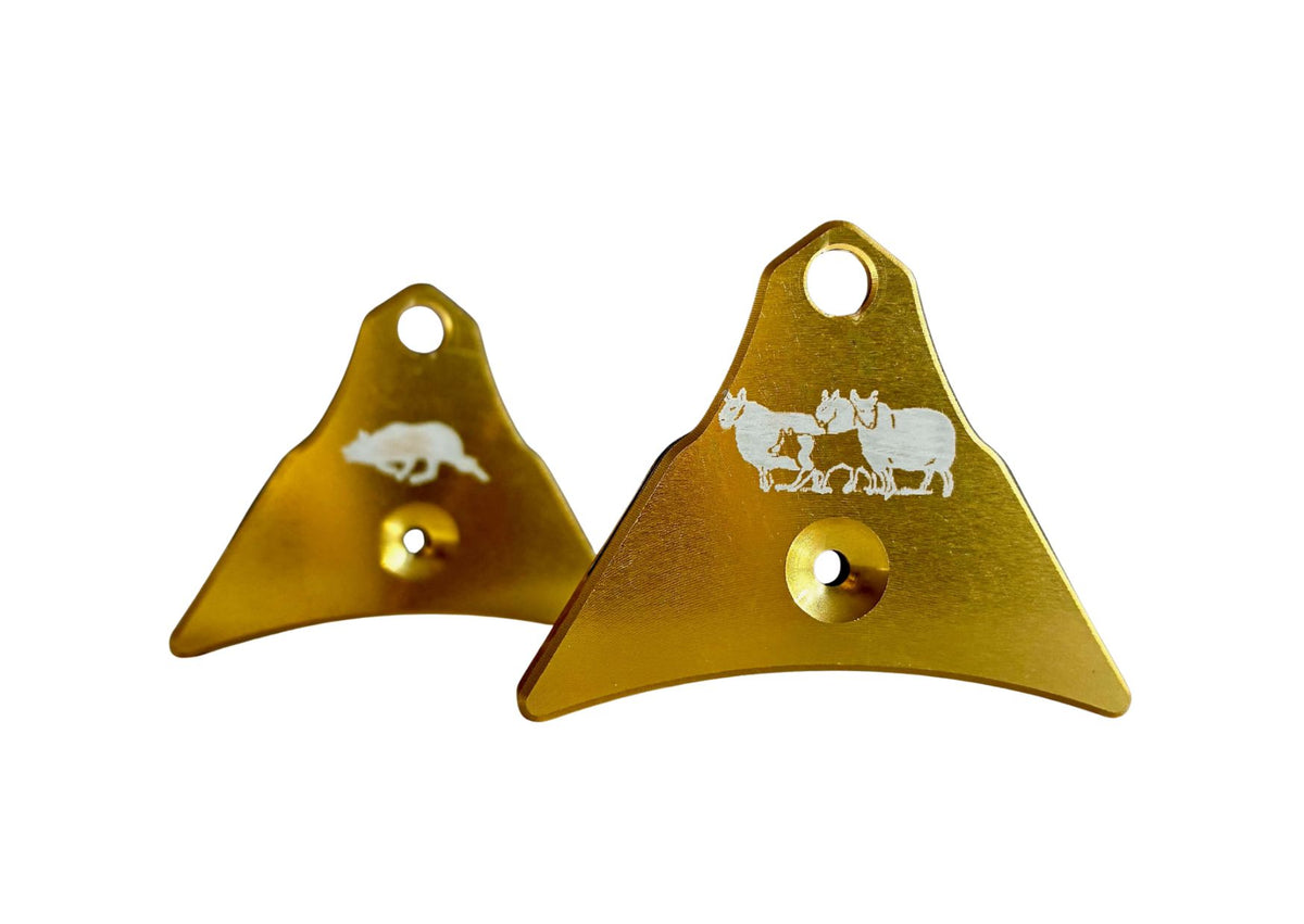 Two Logan Centura with gold finish engraved with white sheep and Border Collie design, shown on a plain white background.