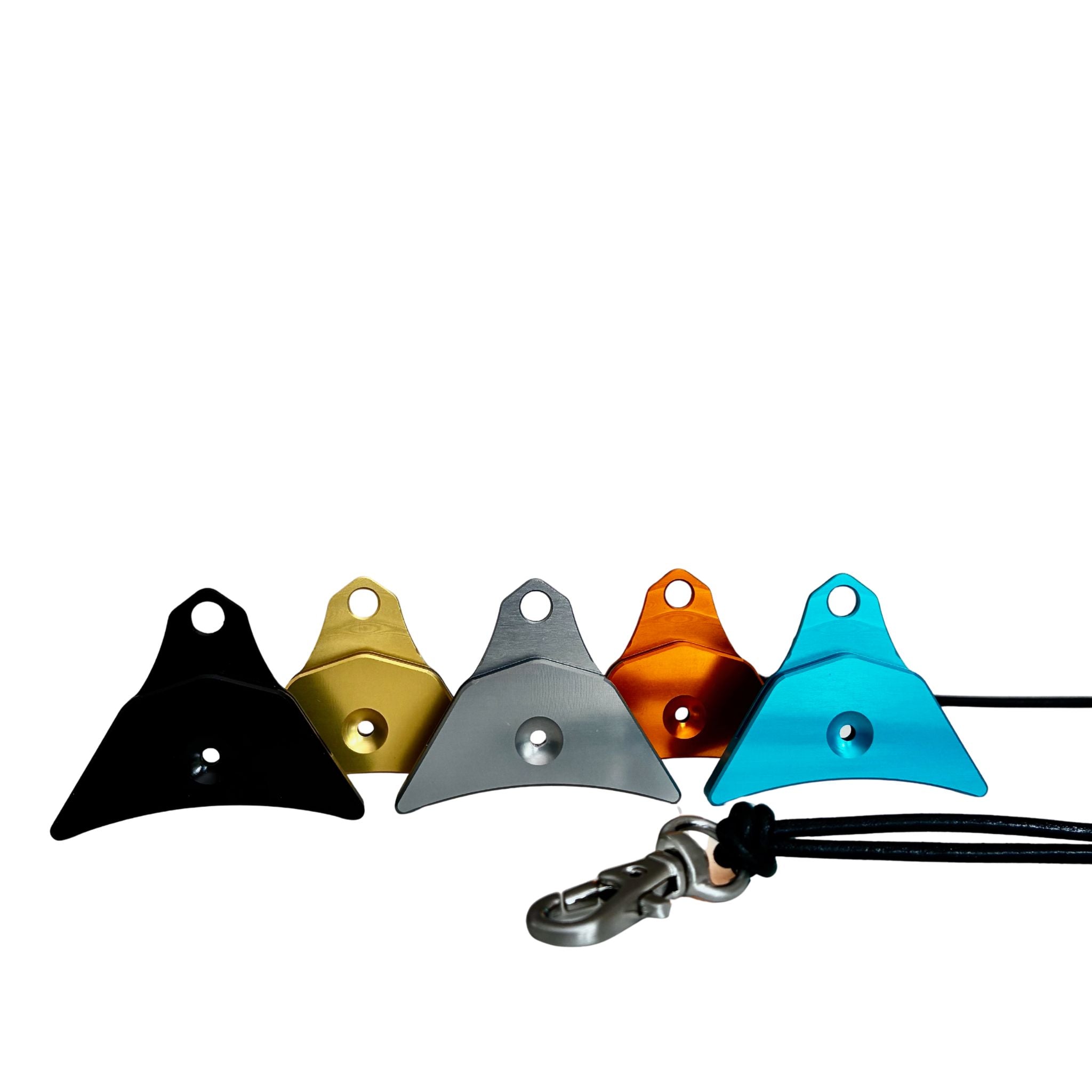Five Logan ventura sheepdog whistles black, gold, grey, ornage and blue  and a black leather cord lanyard with a silver swivel clip on a white background.