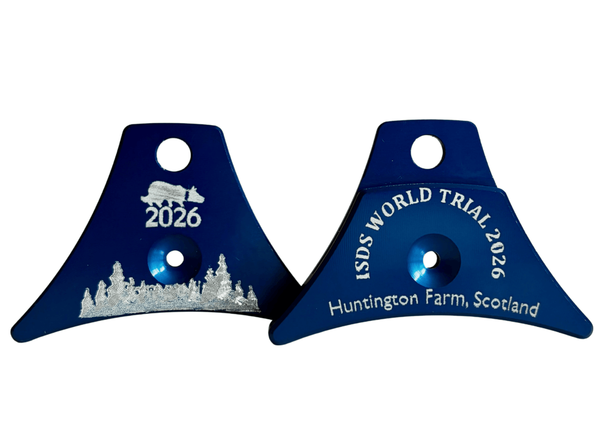 Two Loagn A1 Blue sheepdog whistles shown on a white background. Engraved with'ISDS WORLD TRIAL 2026' and 'Huntington Farm, Scotland' in white.